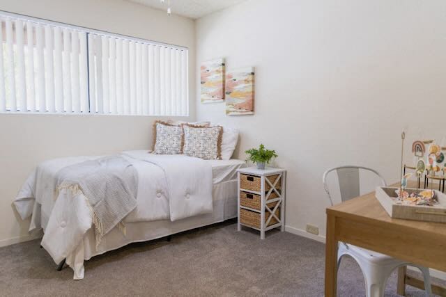 A bedroom in a model apartment at Cranbrook.